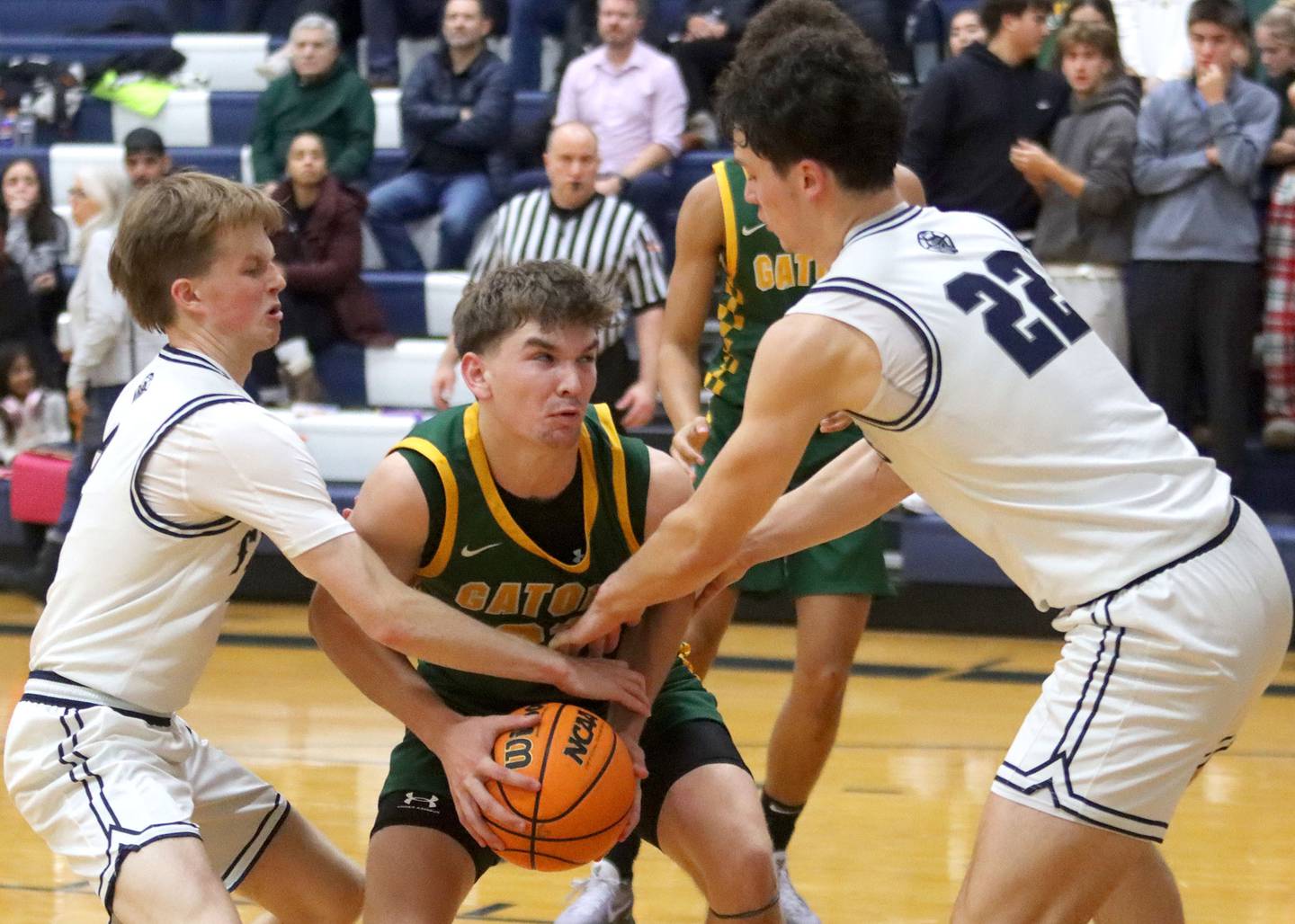 Cary-Grove’s AJ Berndt, left, and Adam Bauer, right, guard Crystal Lake South’s Nick Stowasser, center, in varsity boys basketball on Wednesday, Dec. 3, 2025, at Cary-Grove High School in Cary.