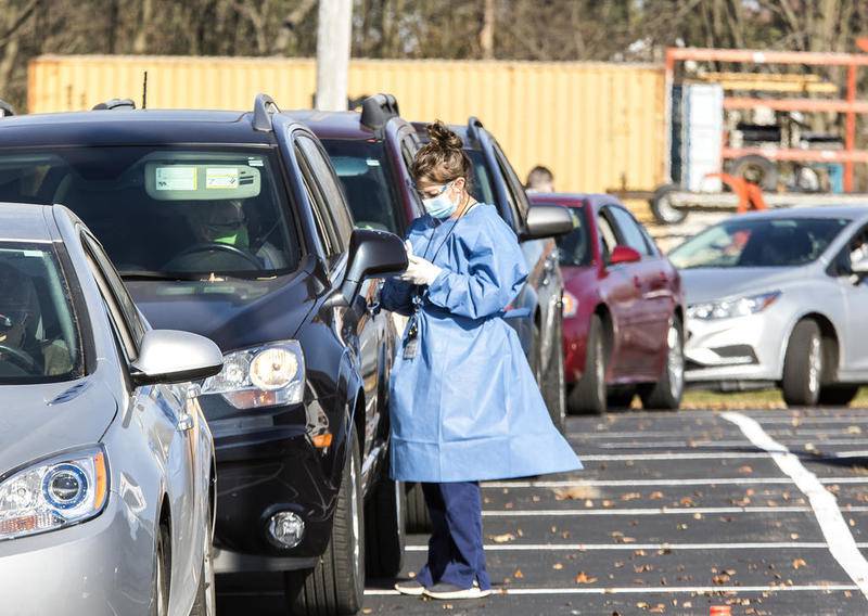 A testing site worker talks with a driver Nov. 5 during a mobile COVID-19 testing event outside the Elks Lodge in Dixon. The event offered free nasal swab tests to anyone who arrived at the event.