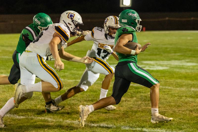 Devon Daemicke (4) of Seneca runs ball whilst being trailed by (left) Collin Swieszcz (50) and Aaron Gibbs (17) of Chicago Christain on Friday, Aug 29, 2025 at Seneca High School in Seneca.