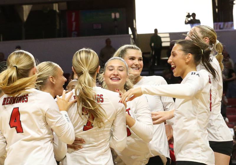 Members of the Benet Academy volleyball team celebrate after defeating Huntley during the Class 4A State semifinal game on Friday, Nov. 15, 2024 at CEFCU Arena in Normal.