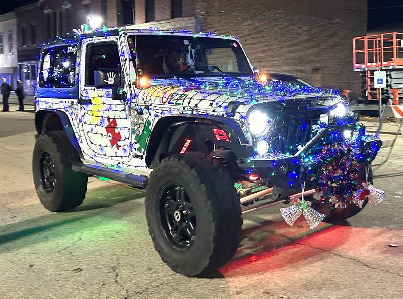 A decorated Jeep travels down Wesley Ave. in the lighted parade during Mt. Morris' Christmas in the Village on Saturday, Dec. 7, 2024.