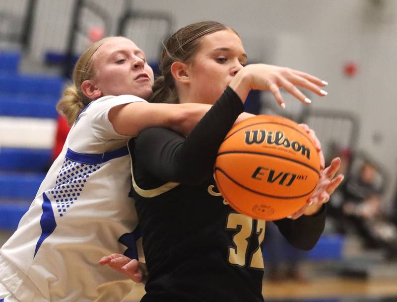 Burlington Central’s Ashley Waslo, left, reaches for the ball from Sycamore’s Quinn Carrier in girls basketball at Burlington Central High School in Burlington on Tuesday, November 18, 2025.