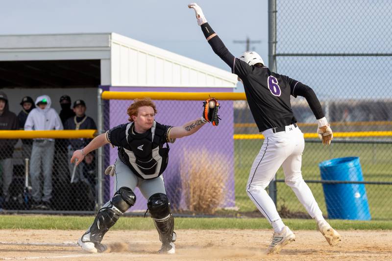 Serena's Payton Twait (6) tries to jump away from the tag of Hiwatha catcher Tommy Butler Monday, April 7, 2025, at Serena High School in Serena.