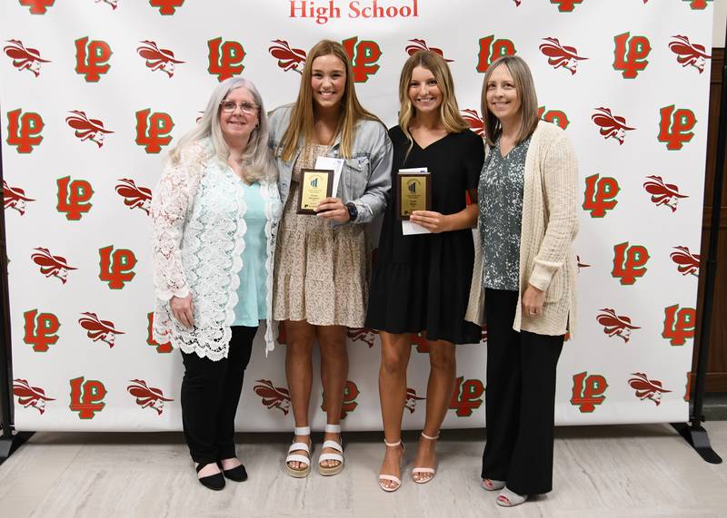 Emma Garretson (middle left) and Taylor Martyn (middle right) received the Business Education Award from L-P Business Division Chairwoman Tiara Bedenko-Hill and Kim Watts of Peru Federal Savings Bank.