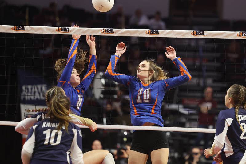 Genoa-Kingston’s Alivia Keegan (8) and Ryulie Stoffregen (10) got for the block against  IC Catholic in the Class 2A championship match on Saturday in Normal.