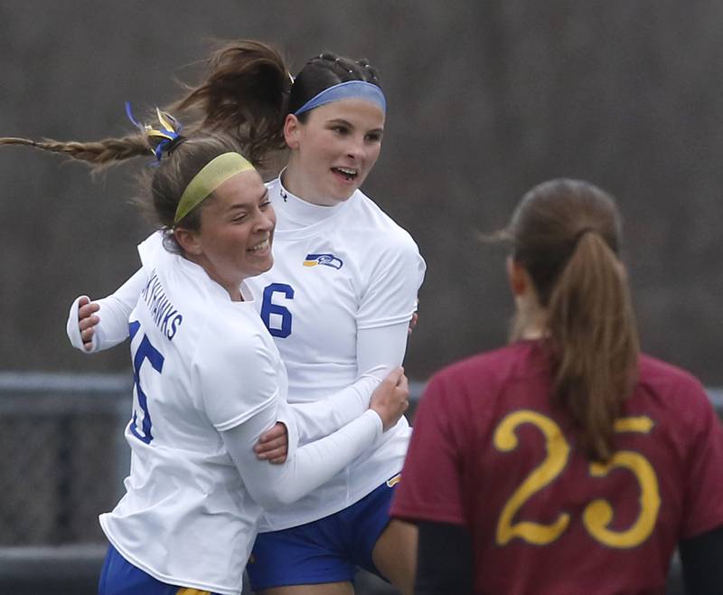 Johnsburg's Elizabeth Smith (center) celebrates her goal with teammate Lauren McQuiston, in front of Richmond-Burton’s Nadia Layer during a Kishwaukee River Conference soccer game against Richmond-Burton on Tuesday, April 1, 2025, at Richmond-Burton High School.