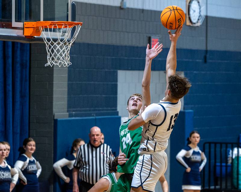Layten Gerdes (13) of Fieldcrest shoots ball over Trevor Jensen (24) of Dwight on Monday, December 15, 2025 at Fieldcrest High School in Minonk.