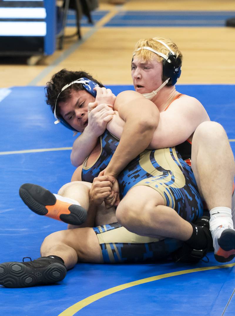 Crystal Lake Central's Tommy McNeil, right, gets control of Wheeling's Eddie Juarez during the 215 pound bout at the Class 2A Dual Team wrestling Sectional on Tuesday, February 25, 2025 at Wheeling High School. Ryan Rayburn for Shaw Local