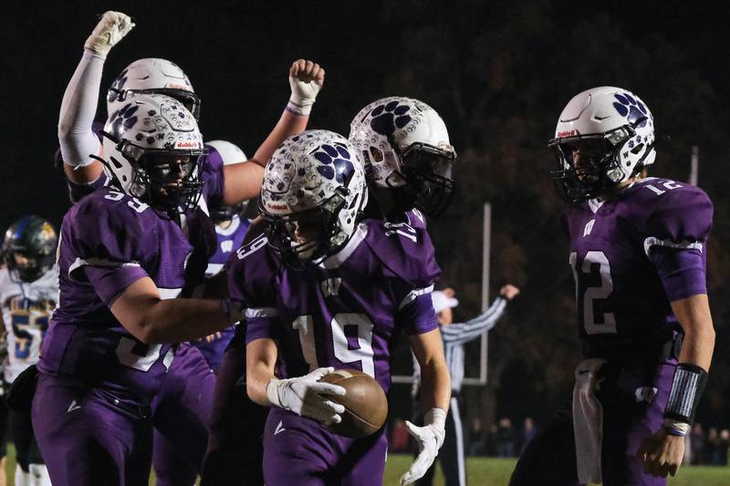 Wilmington's Colin James is greeted by teammates after his touchdown run against Tri-Valley in the Class 2A semifinal. Saturday, Nov.20, 2021 in Wilmington.