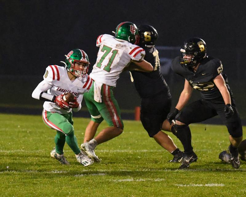 LaSalle-Peru Adrian Arzola (6) gains a few yars in the first half the game while traveling to take on Sycamore High School.