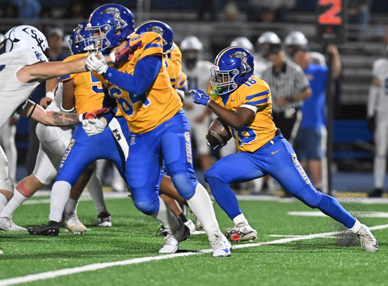 Joliet Central's Tristen Sellers (18) runs the ball during the conference game against Plainfield South on Friday, OCT. 17, 2025, at Joliet.