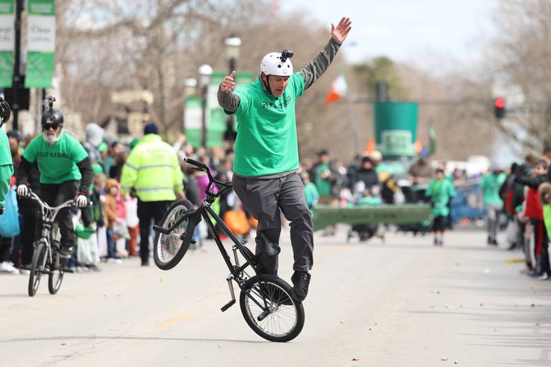 A cyclist performs tricks in the Plainfield Hometown Irish Parade on Sunday, March 17, 2024 in Plainfield.