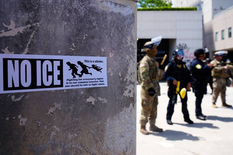 DHS police and National Guard protect the outside the Metropolitan Detention Center, Wednesday, June 11, 2025, in Los Angeles. (AP Photo/Damian Dovarganes)