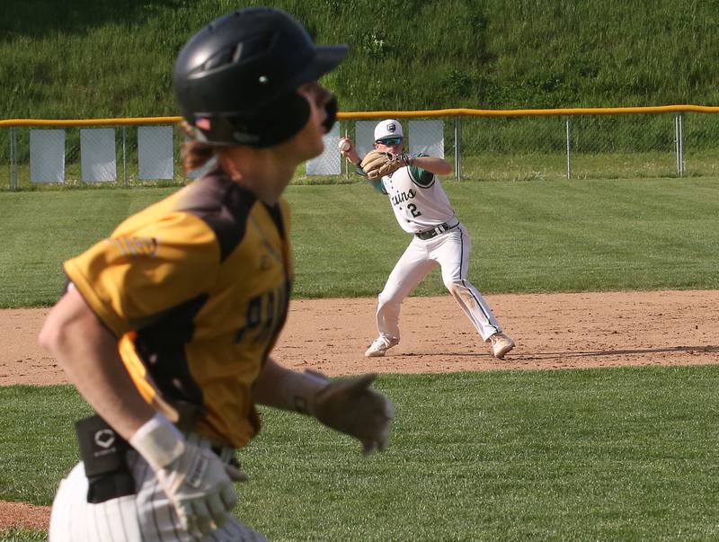 St. Bede's Guss Burr throws across the diamond to force out Putnam County's Miles Main on Tuesday, April 30, 2024 at St. Bede Academy.