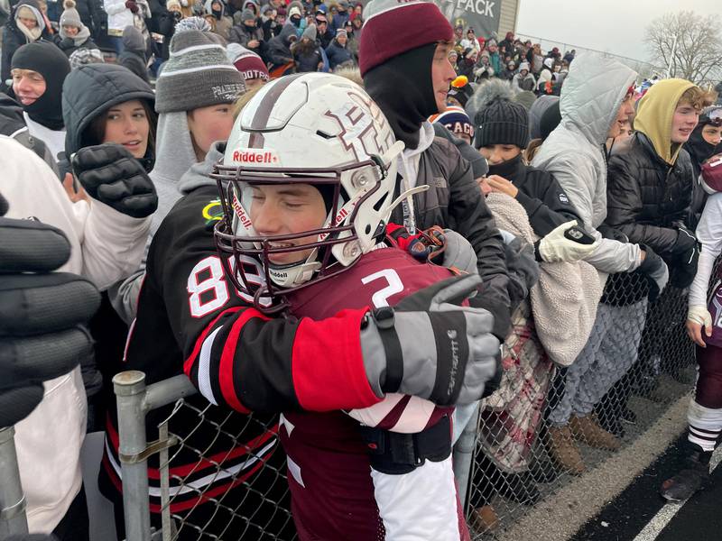 Prairie Ridge players and fans celebrate a Class 6A football playoff semifinal win at Crystal Lake on Saturday. The Wolves advanced to the state title game with their win over St. Ignatius.