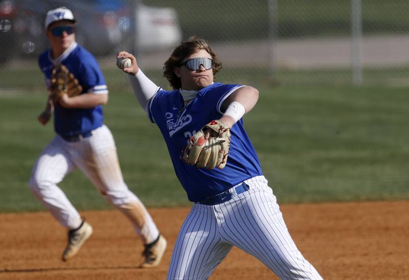 Woodstock’s Dan Elswick throws the ball to first as he tries to get the runner out during a Kishwaukee River Conference baseball game against Woodstock North Tuesday, April 18, 2023, at Emricson Park.