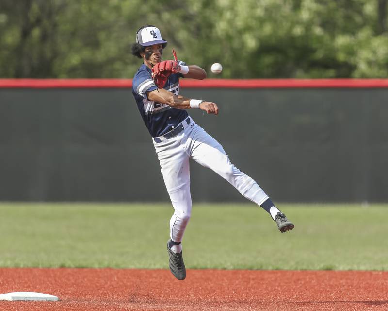Oswego East's Jacsen Tucker (17) throws to first for an unassisted double play during baseball game between Oswego East at Yorkville. Monday, May 12, 2025 in Yorkville.