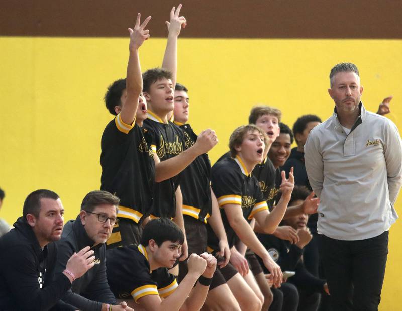 Jacobs’ players and coaches get revved up as the Golden Eagles face Grayslake Central in varsity boys basketball Hinkle Holiday Classic action on Tuesday, Dec. 23, 2025, at Jacobs High School in Algonquin.