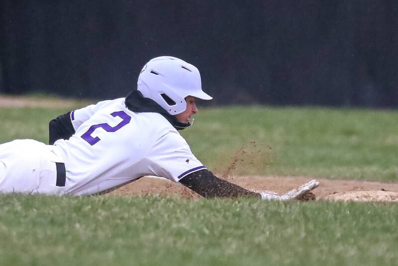 Plano's Justin Bishop (2) dives back to first base during baseball game between Sandwich at Plano on Thursday, April 9, 2025 in Plano.