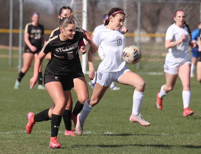 Kaneland's Taylor Mills pushes the ball ahead of Sycamore's Grace Amptmann during their game Monday, April 14, 2025, at Sycamore High School.