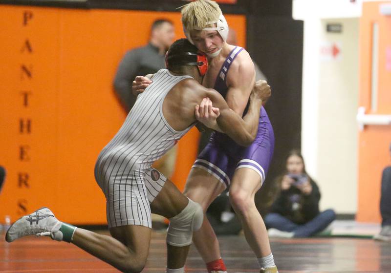 Plano's Caidan Ronning wrestles Rockridge's Ty Smart in the 157 weight class during the Class 2A Sectional championship on Saturday, Feb. 15, 2025 at Washington High School.