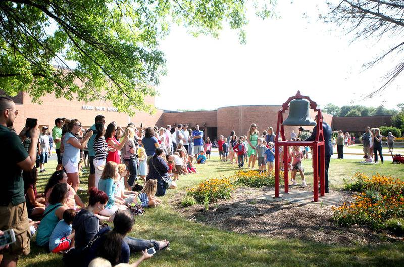 Students at Louise White School in Batavia ring the school's bell as part of first day of school festivities Aug. 16.