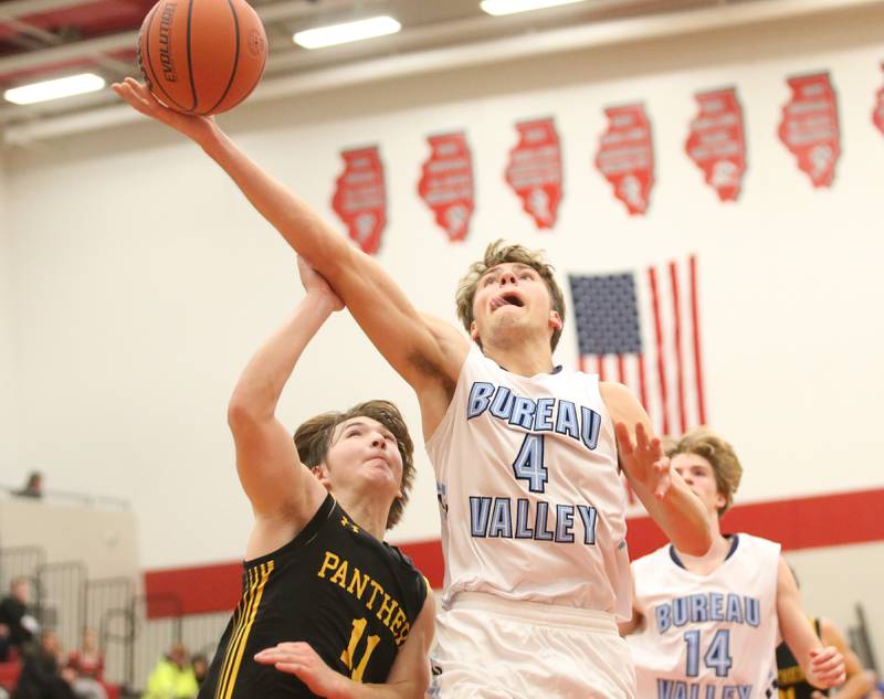 Bureau Valley's Landon Hulsing drives to the basket over Putnam County's Owen Saepharn during the 49th annual Colmone Class on Thursday, Dec. 7, 2023 at Hall High School.