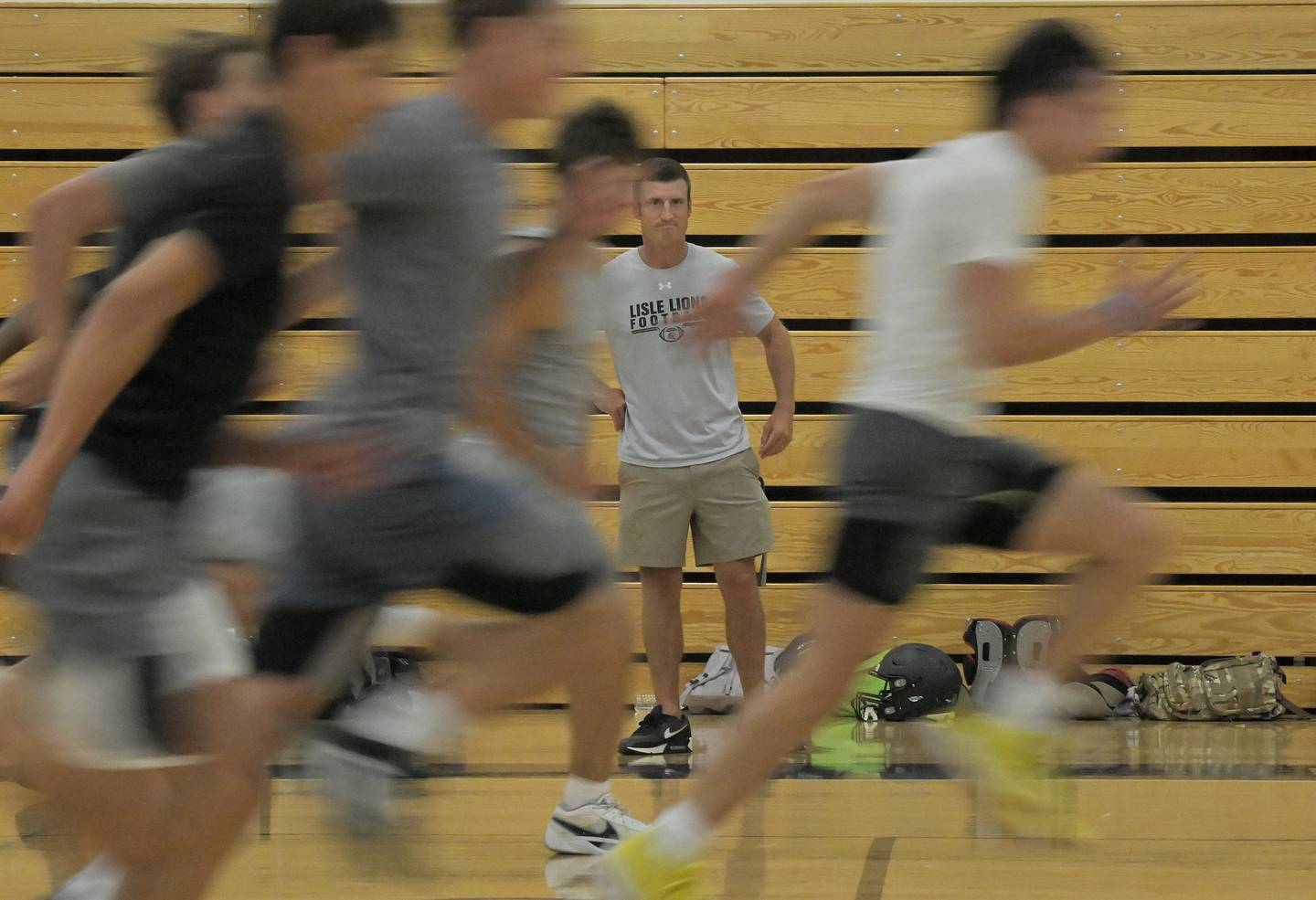 Coach Cory Dillard watches his team run sprints at Lisle High School football practice in the school gymnasium on Tuesday, August 12, 2025.