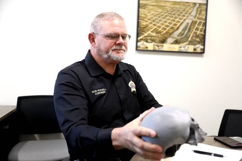 Kane County Coroner Rob Russell holds a 3-D print of the skull found in the wall of a Batavia home in 1978 during a renovation. This year, the identify of the woman it belonged to was discovered, her great grandson was found and her skull was interred.