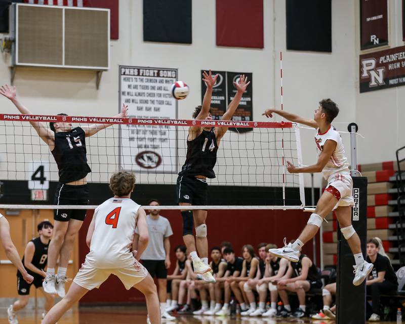 Plainfield East's Nathan Grutza (5) smashes the ball during volleyballl match between Plainfield East at Plainfield North.  May 18, 2023.