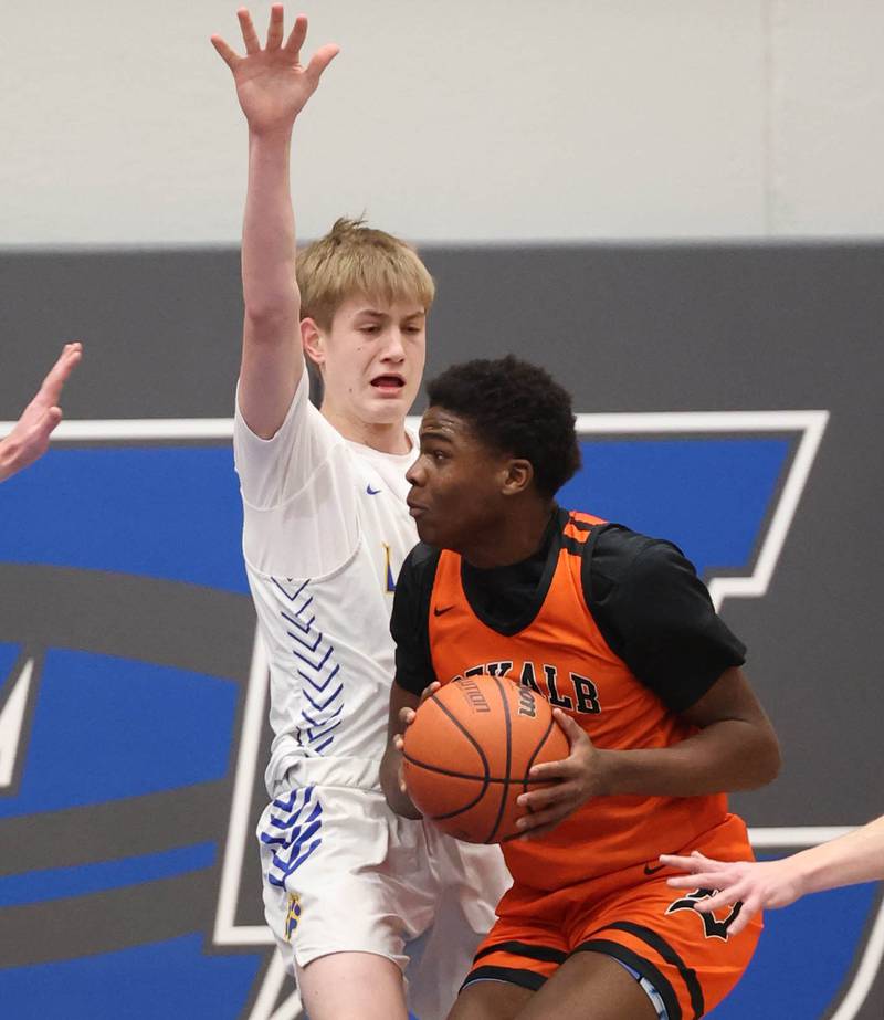 Lyons Township's Ian Polonowski stops DeKalb’s Davon Grant in the lane Monday, Jan. 15, 2023, during their game in the Burlington Central Martin Luther King Jr. boys basketball tournament.