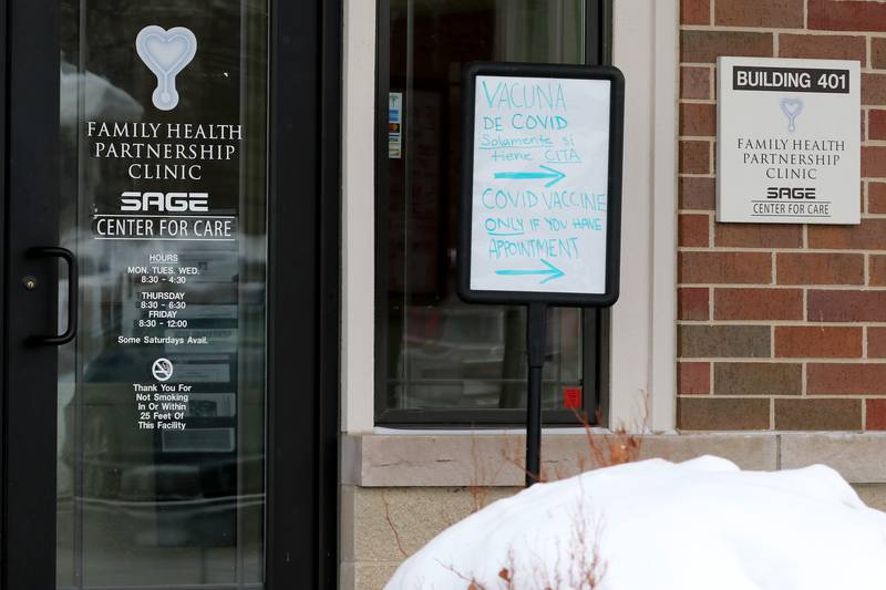A sign in both English and Spanish details information for clients with appointments for a COVID-19 vaccine at Family Health Partnership Clinic on Thursday, Feb. 18, 2021, in Crystal Lake.