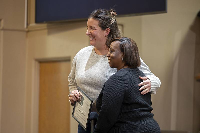 Varsity basketball coach and Sterling High School leader Taylor Jackson (left) was awarded the MLK Peace and Justice Award by Sauk Valley Divinity Alliance president Tina Wren Sunday, Jan. 19, 2025, in Sterling.