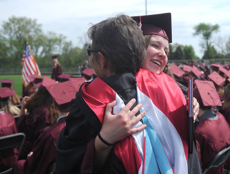 Teacher Kelly MacDonald is hugged by Sam Kral Saturday, May 14, 2022, during the graduation ceremony at Prairie Ridge High School.