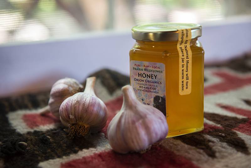 Guests of Tim Benedict receive gifts of honey and garlic from his farm.