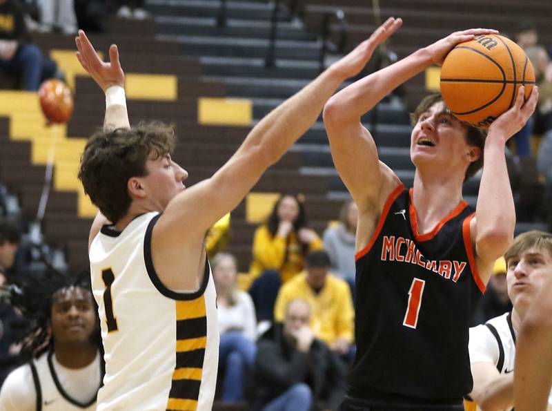McHenry's Dylan Hurckes shoots the ball over Jacobs' Ben Jurzak during a Fox Valley Conference basketball game on Friday, Jan. 24, 2025, at Jacobs' High School.