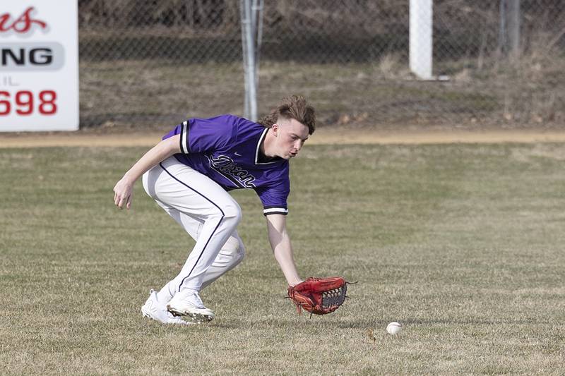 Dixon’s Tyler Shaner fields a ball in left field Monday, March 20, 2023 against Rockford Guilford.