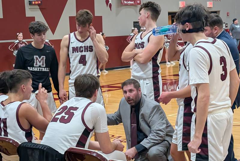 Marengo boys basketball coach Jeremy Burke talks to his time during a third-quarter timeout against Harvard on Friday, Jan. 17, 2025, at Marengo.