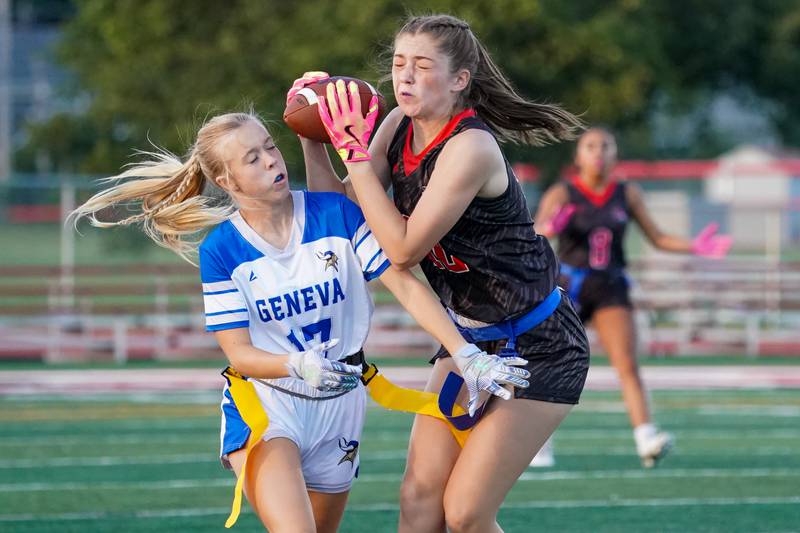 Yorkville's Annabel West (right) catches a pass over Geneva’s Violet Warnke (17) during a non-conference game at Yorkville High School on Tuesday, Sept. 2, 2025.