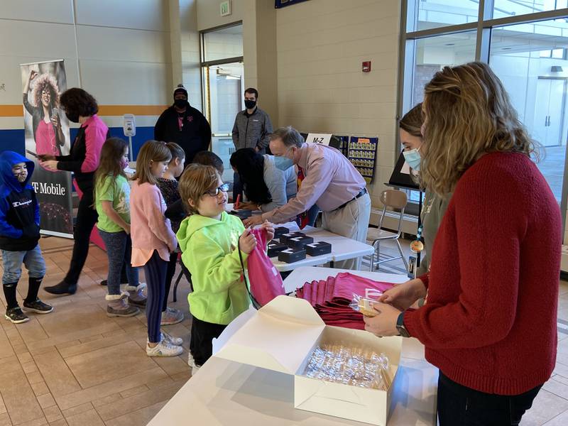 Woodstock School District students receive internet connectivity devices Tuesday, Feb. 8, 2022, as a part of T-Mobile's Project 10Million at  Prairiewood Elementary School in Woodstock.