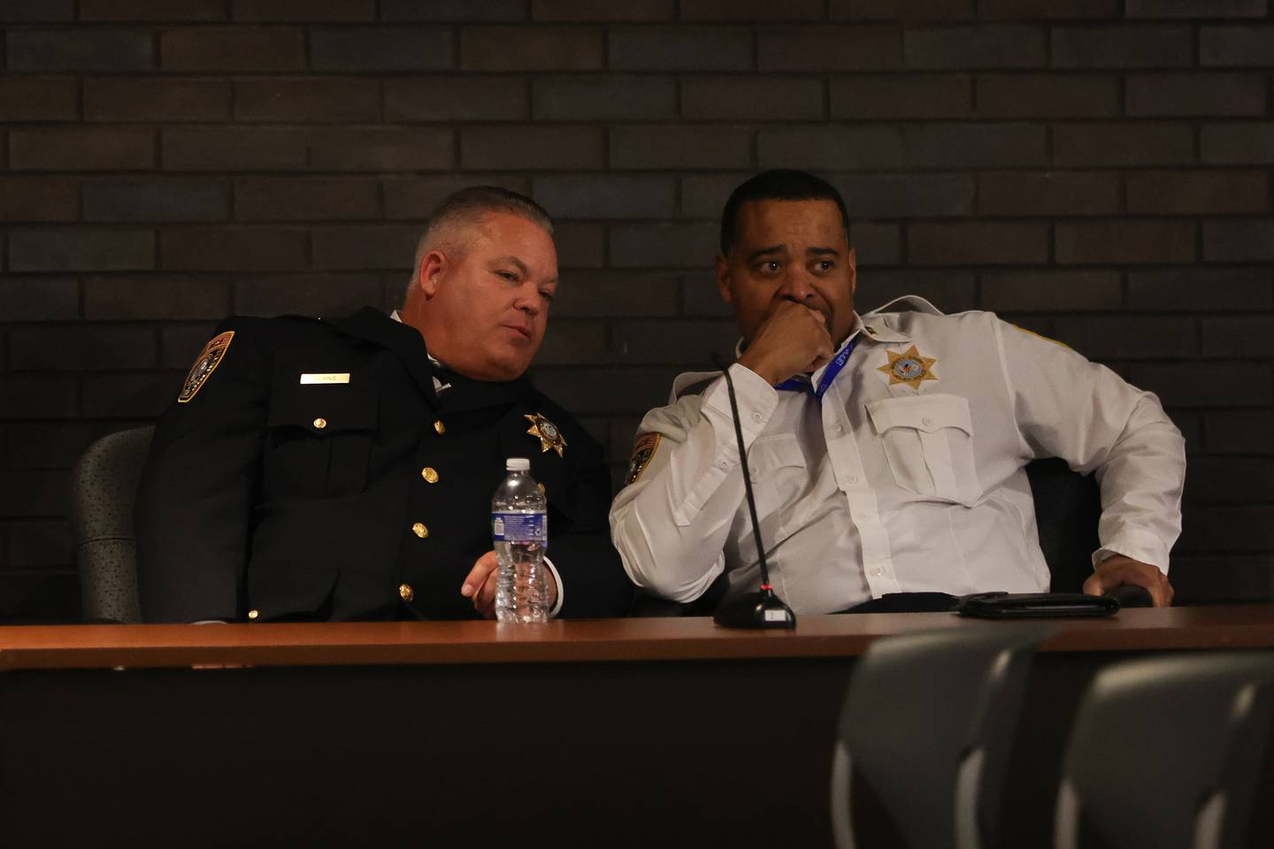 Joliet Police Chief William Evans talks with the former interim Joliet Police Chief Robert Brown at the Joliet City Council Meeting. Tuesday, Mar. 1, 2022, in Joliet.