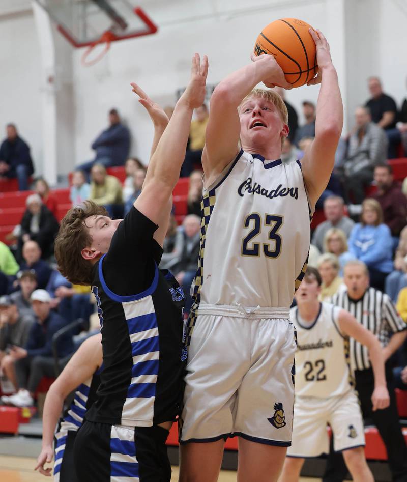 Marquette's Luke McCullough shoots over Hinckley-Big Rock's Luke Badal Tuesday, March 3, 2026, during their sectional semifinal matchup at Amboy High School.
