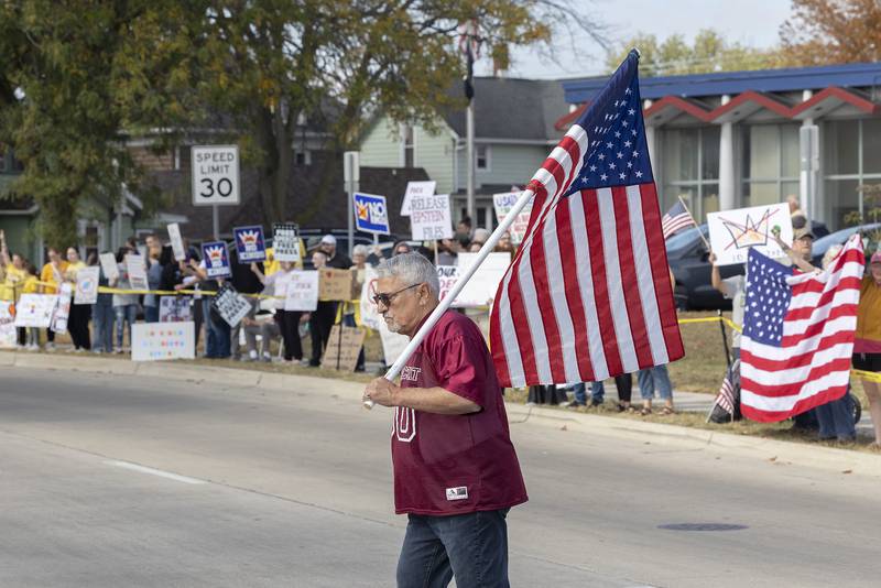 A protester crosses the street in Sterling on Saturday, Oct. 18, 2025, during the “No Kings” rally. The Sterling demonstration was just one of thousands across the United States and Europe.