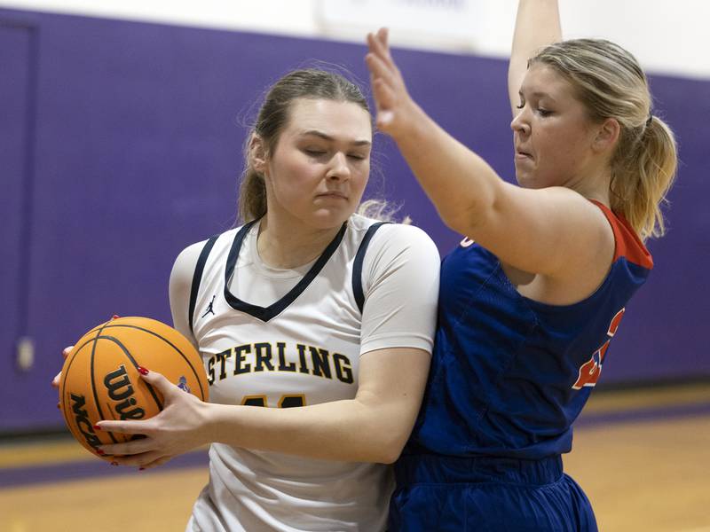 Sterling’s Natalie Eddinger works against Eastland’s Olivia Klinefelter Thursday, Dec. 26, 2024, during the Dixon Girls Holiday Basketball Tournament.