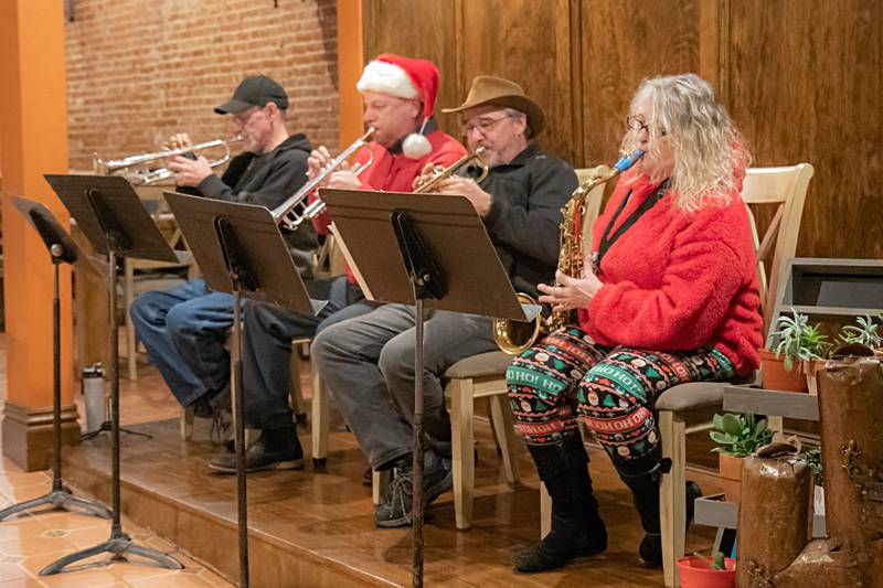 The Dixon Municipal Band plays indoors at Salamandra's due to the misty weather during the Dixon Christmas walk Friday, Dec. 1, 2023.