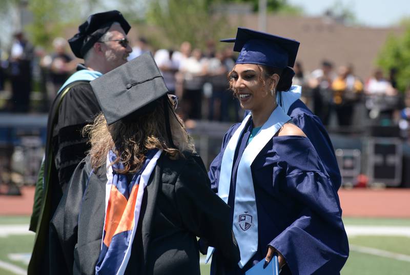 Downers Grove South graduates including Alexa Harris receive their diploma  during the graduation ceremony Sunday May 21, 2023.