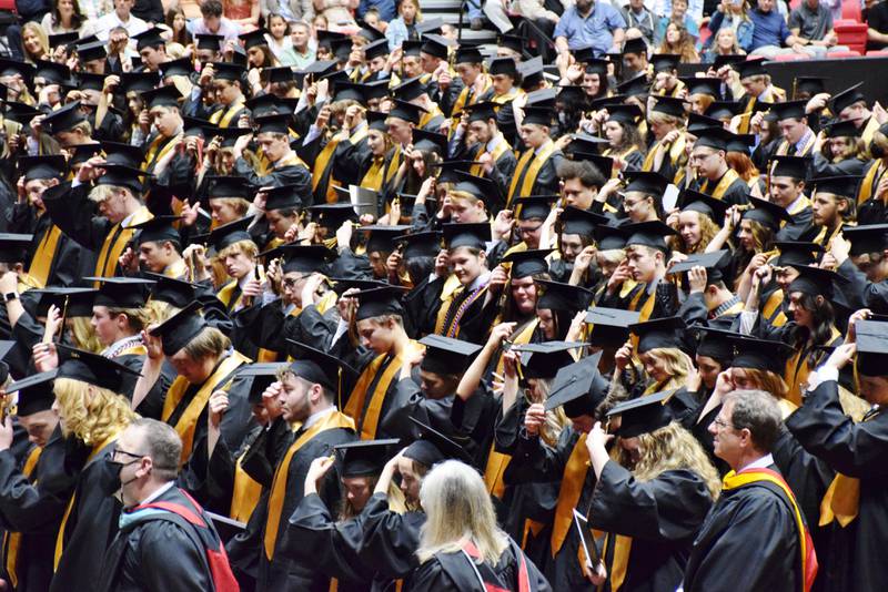 Sycamore High School's Class of 2022 moves the tassels on their graduation caps during their commencement ceremony, held Sunday, May 22, 2022 at Northern Illinois University's Convocation Center in DeKalb.