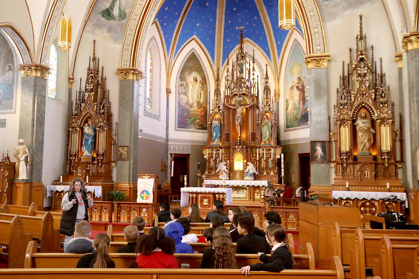 Vickie Jankovish talks with middle school students from St. John the Baptist Catholic Academy as they prepare to clean St. John the Baptist Catholic Church on Thursday, Jan. 29, 2026, in Johnsburg. The students help clean parts of the church as a community service project.