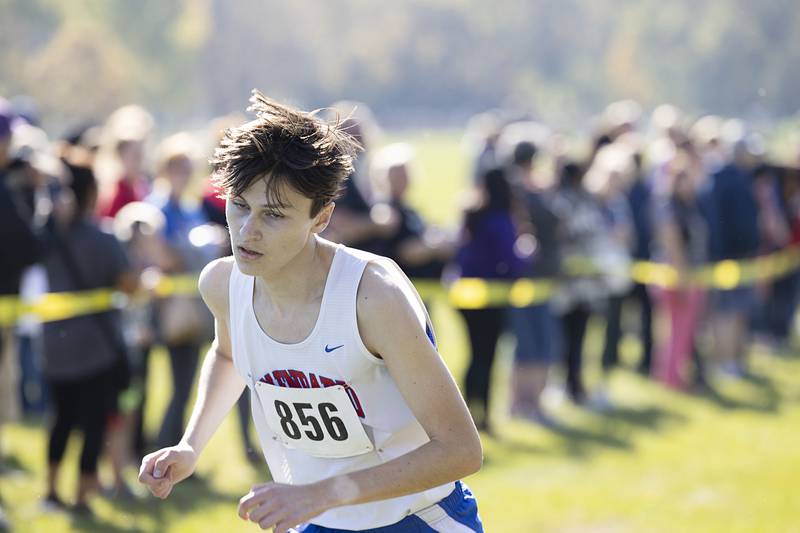 Jaden Frederick of Glenbard South guts out an 8th place finish Saturday, Oct. 22, 2022 class 2A cross country regional in Sterling.