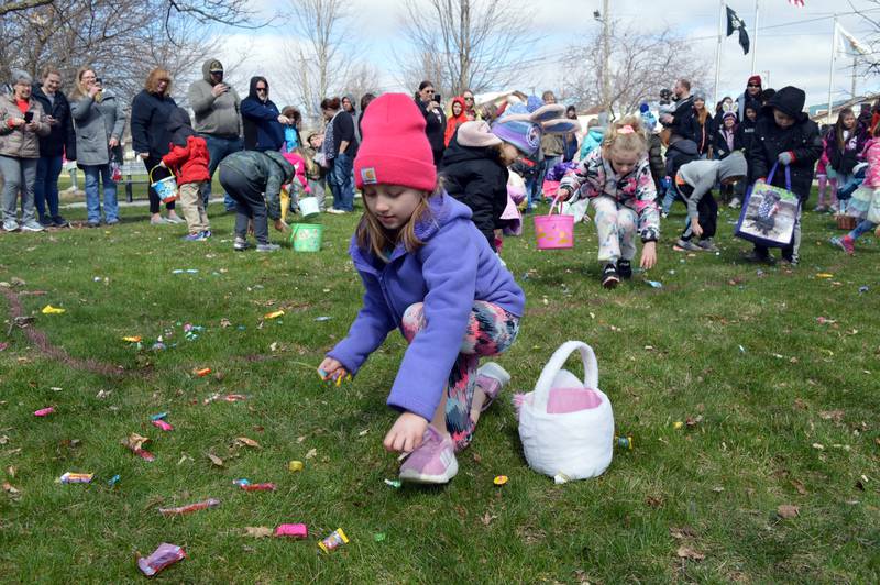Ruby Warren, 6, of Forreston, lunges for several pieces of candy during Forreston's annual Easter egg hunt in Memorial Park on April 16.